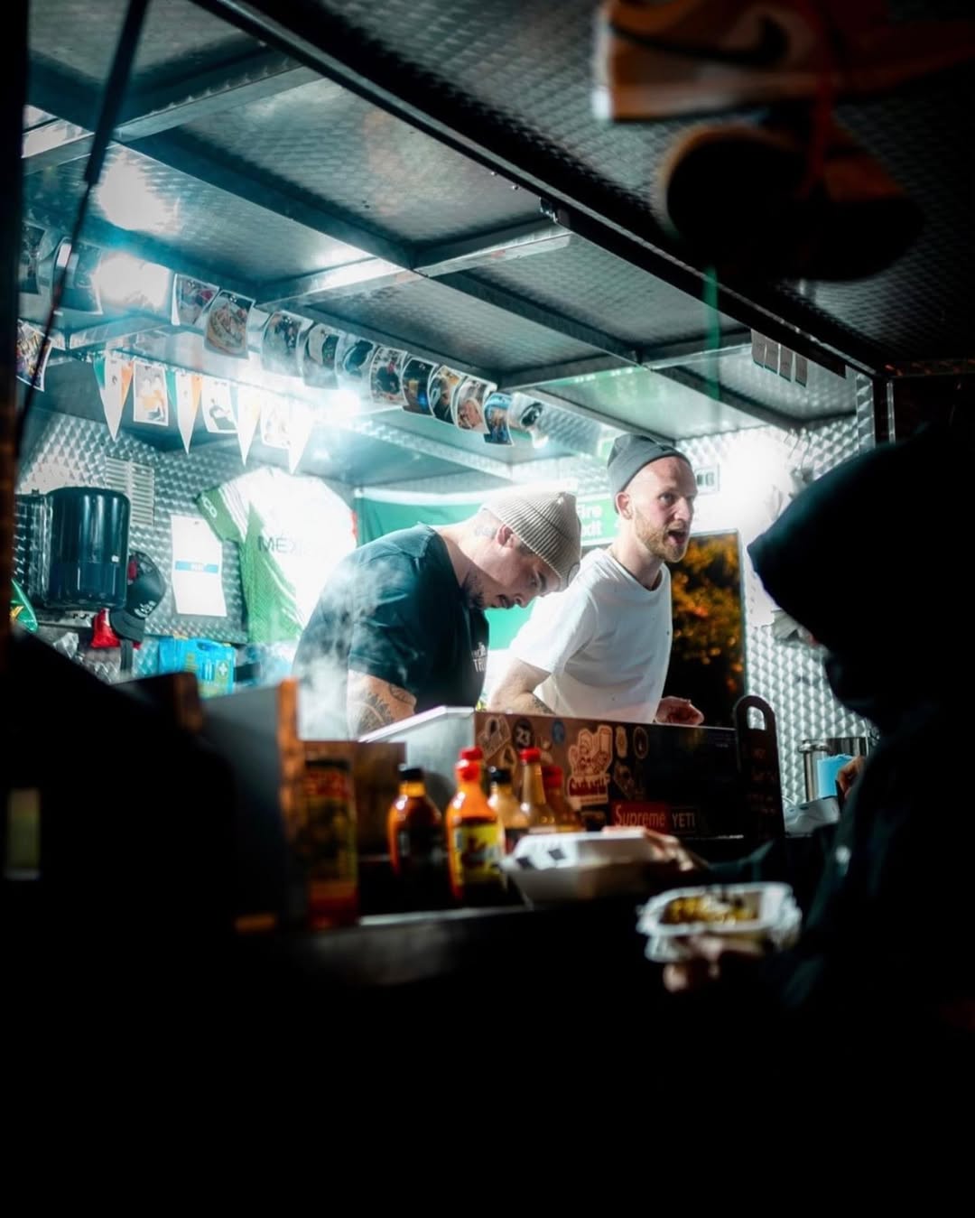 The Big Taquero food truck at night with bright serving-window lighting.